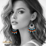 a pair of beaded earrings in a silver frame